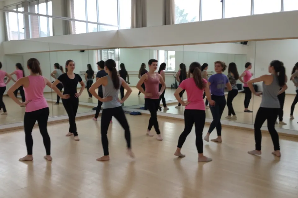 Dancers rehearsing in a mirrored studio